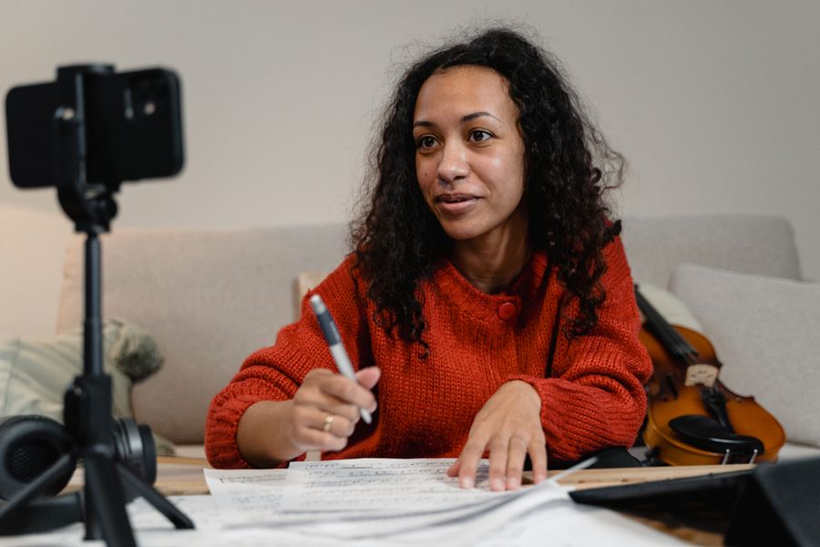 Instructor filming a lesson at her desk. Photo by Tima Miroshnichenko on Pexels