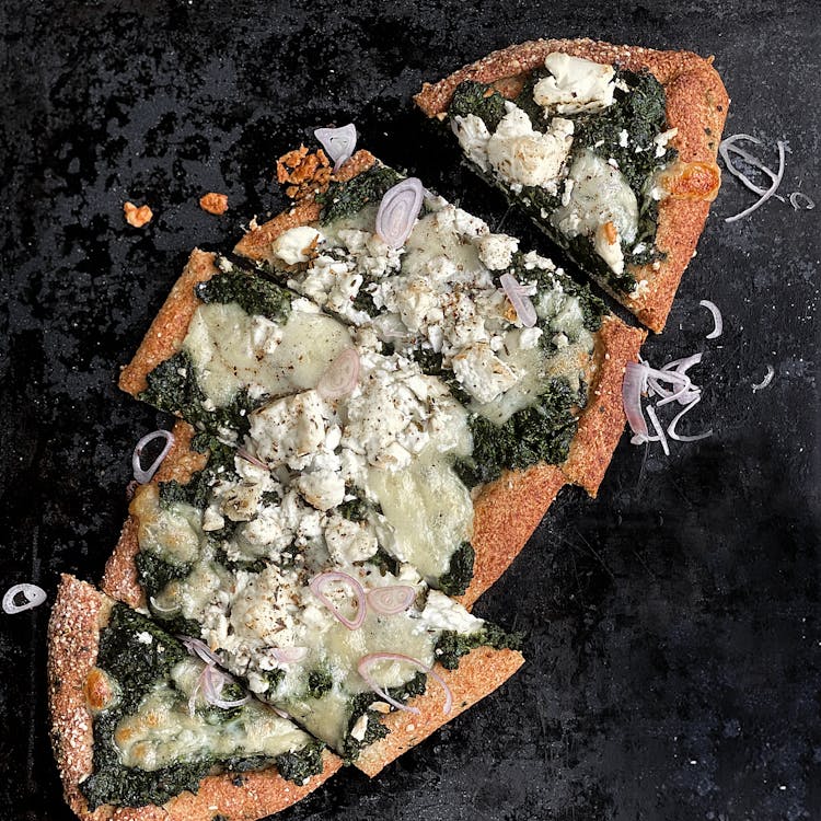 Close Up Of Baked Pizza With Cheese And Spinach