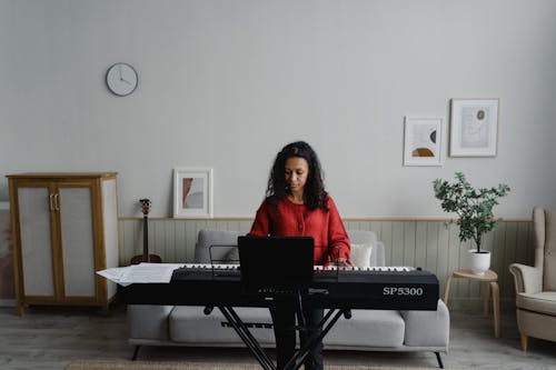 Focused Woman Playing Digital Piano