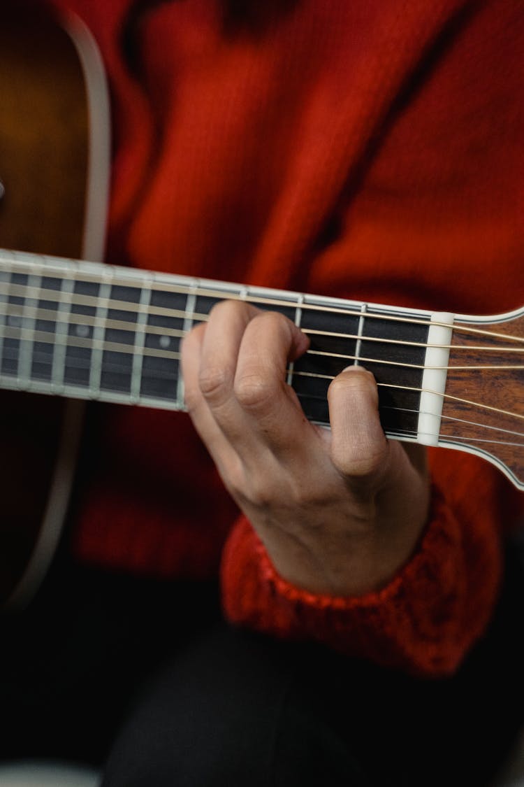 Person In Red Sweater Playing Guitar 