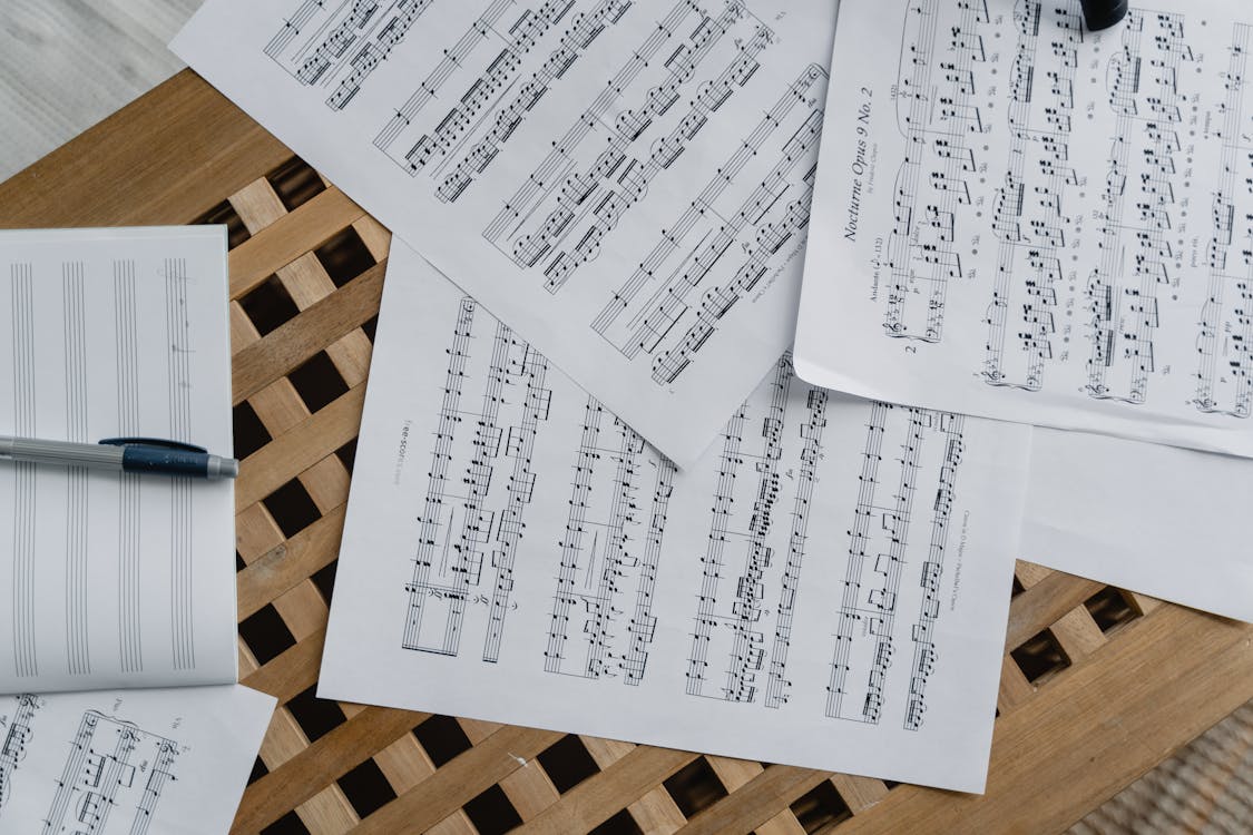 Free Sheet Music on Wooden Surface  Stock Photo