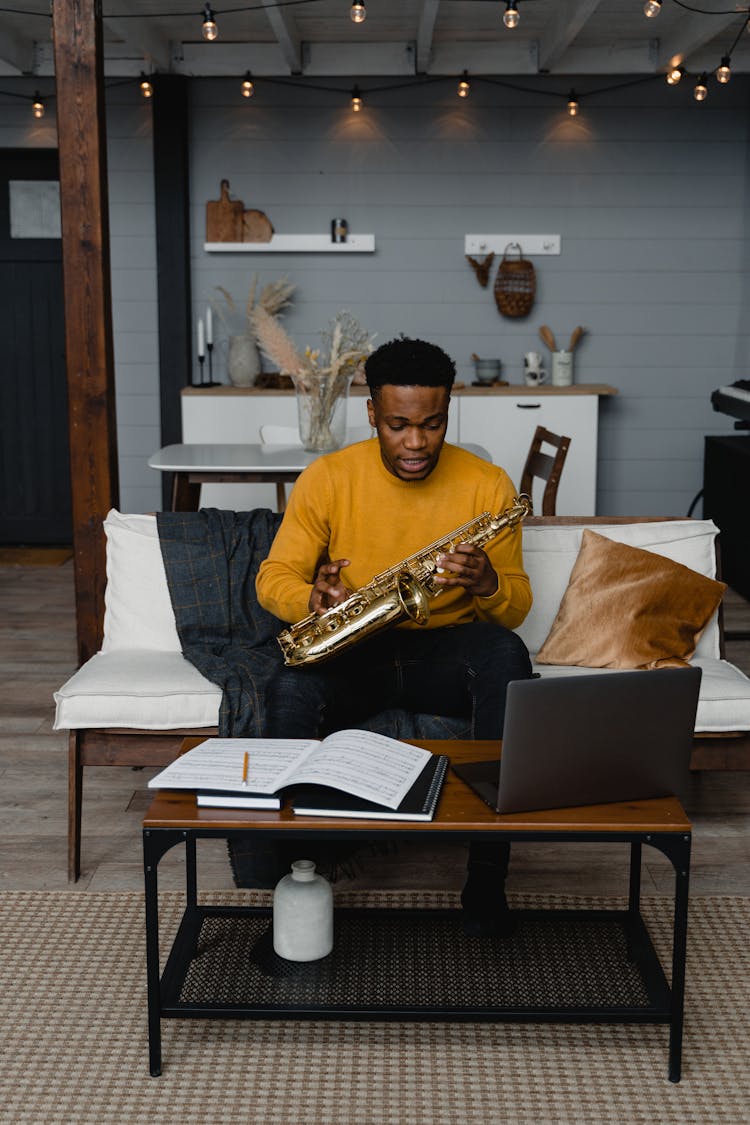 A Man Holding A Saxophone