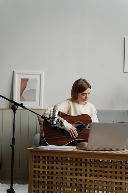 A Woman Learning To Play Guitar Online Free Stock Photo a-woman-learning-to-play-guitar-online-free-stock-photo