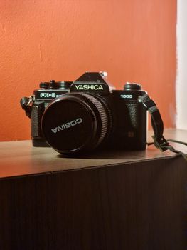 Classic Yashica FX-3 camera with Cosina lens cap, perfect for vintage photography enthusiasts.