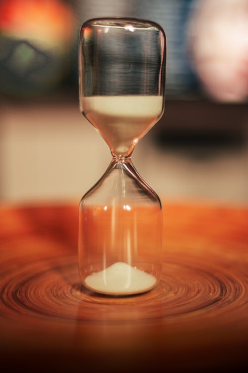 Free Hourglass on Wooden Surface Stock Photo