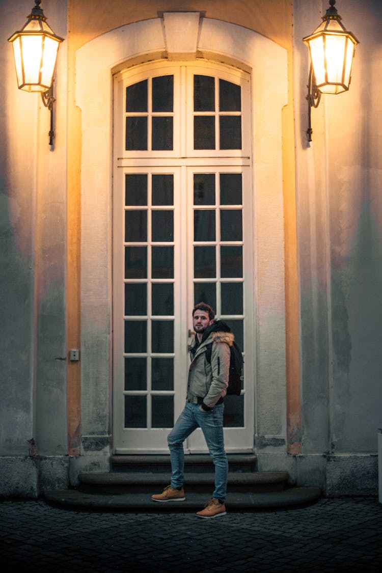 Man Standing In Front Of A Wooden Door