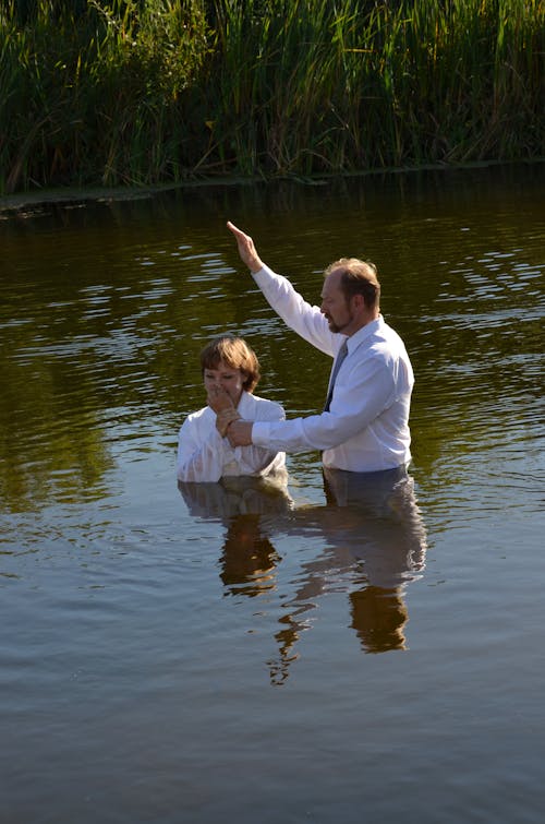 
A Woman being Baptized in a Lake