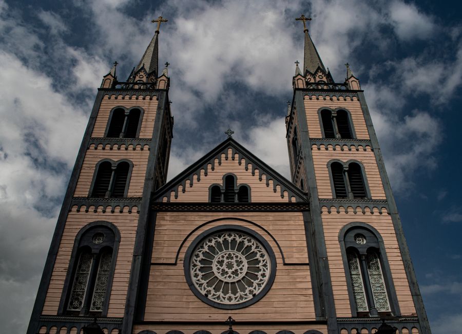 Exterior view of St. Peter and Paul Cathedral showcasing its gothic architecture and twin towers in Suriname.