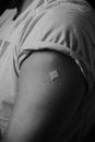 A Person with a Band Aid on the Arm