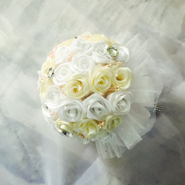 Beautiful bridal bouquet with white and cream artificial roses, perfect for weddings.