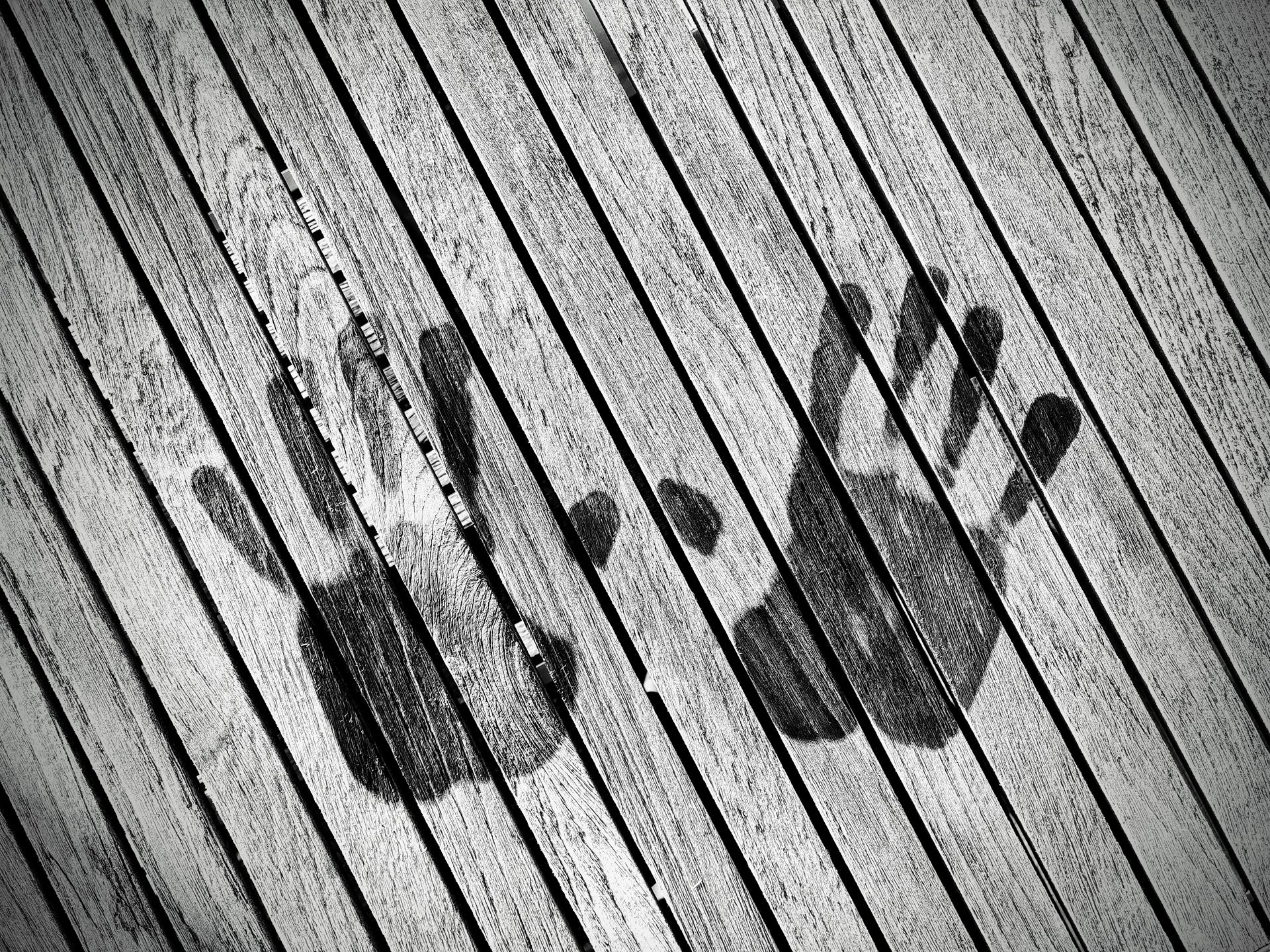 Monochrome image of handprints on wooden slats in Haderslev, Denmark.