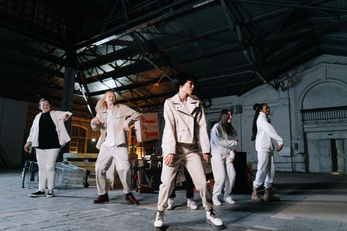 Free A diverse group of people stands in a warehouse, engaging in peaceful protest with signs advocating change. Stock Photo
