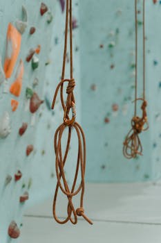 Detailed view of climbing ropes and holds on an indoor wall, ideal for extreme sports enthusiasts.