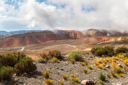 Free Stunning view of the Andean mountains with cloudy skies and vibrant shrubs. Stock Photo