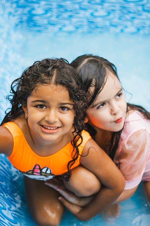 Free Two Little Girls Hugging in a Swimming Pool Stock Photo