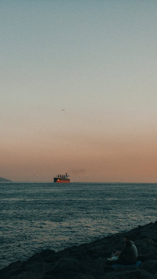 A Ship Sailing on the Ocean During Golden Hour 
