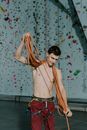 A Shirtless Man Holding a Ropes
