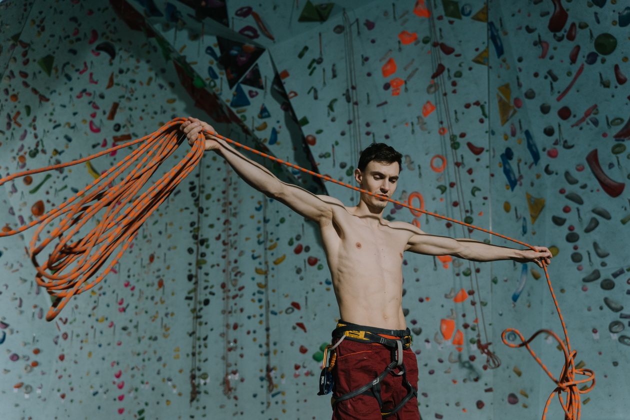 Climber training with ropes indoors