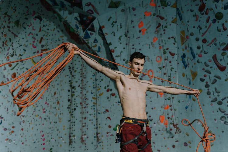 Topless Man Standing With Ropes