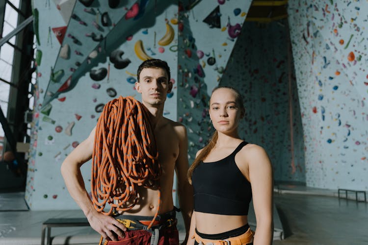 Topless Man And Woman In Sportswear At Sport Climbing