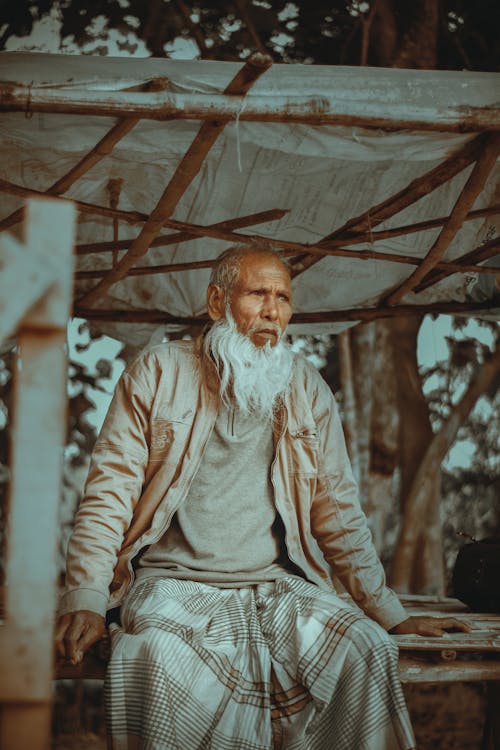 Old Man with Gray Beard Sitting Under the Handmade Tent