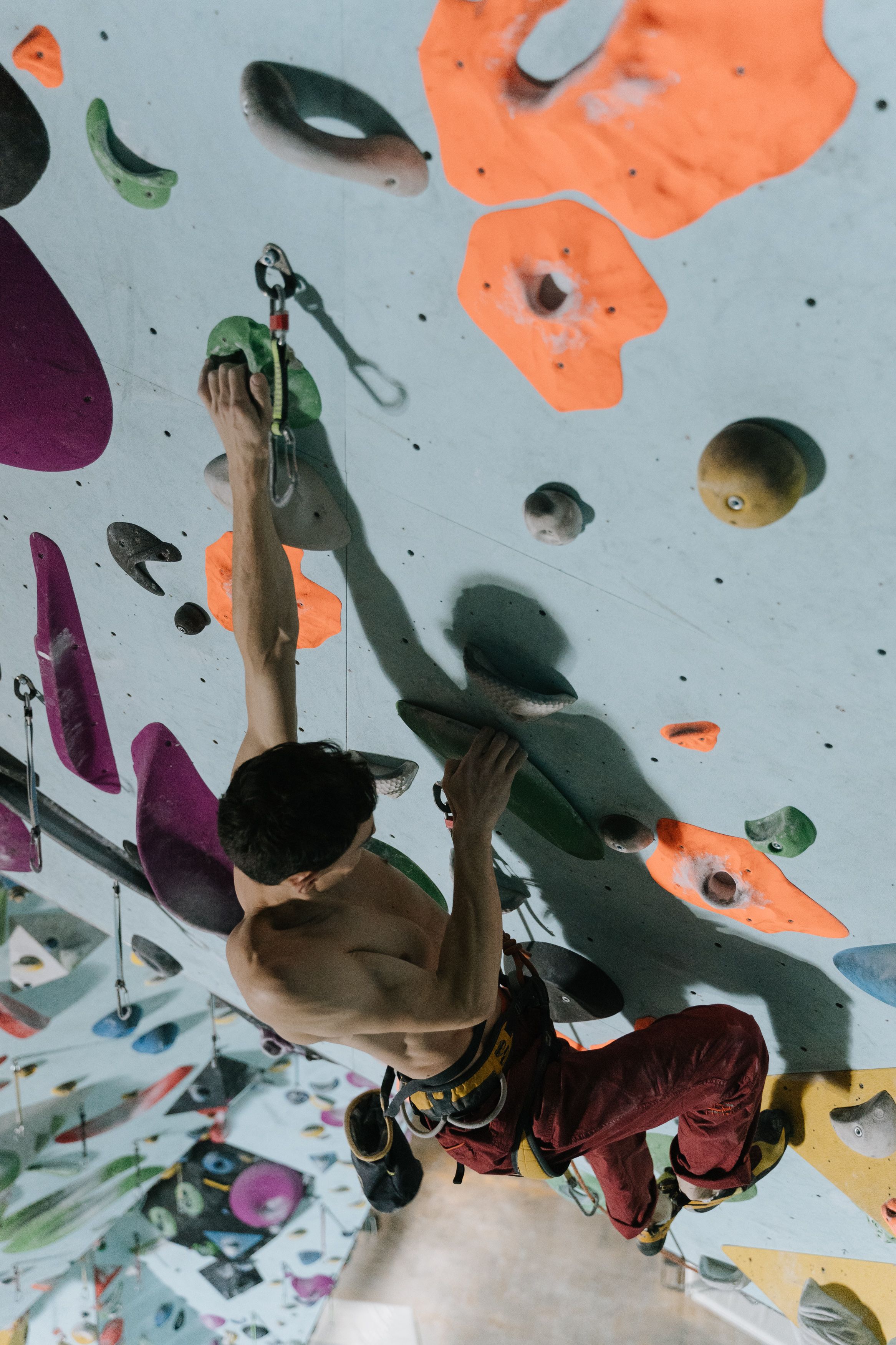 A close-up of a climber's hands and chalk