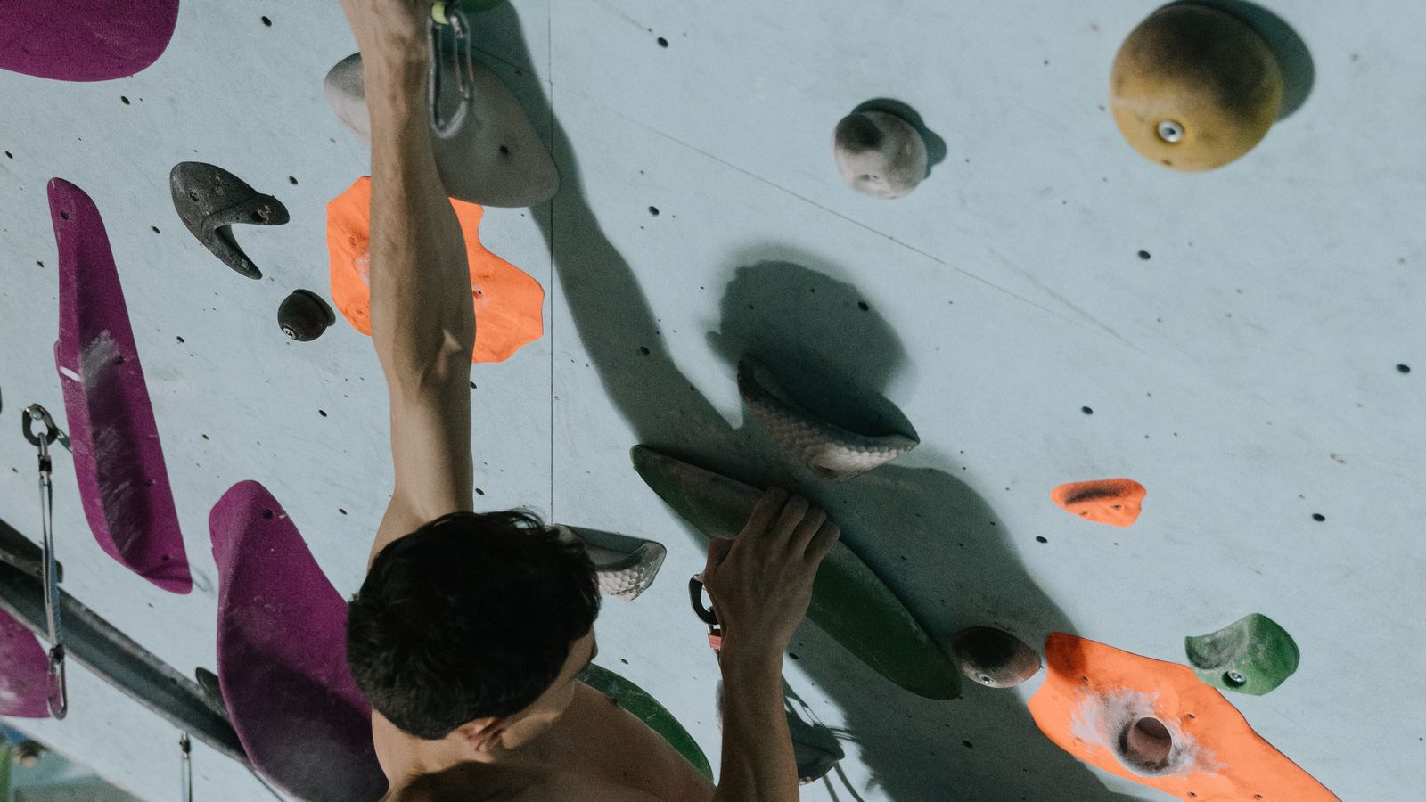 A close-up of a climber's hands and chalk