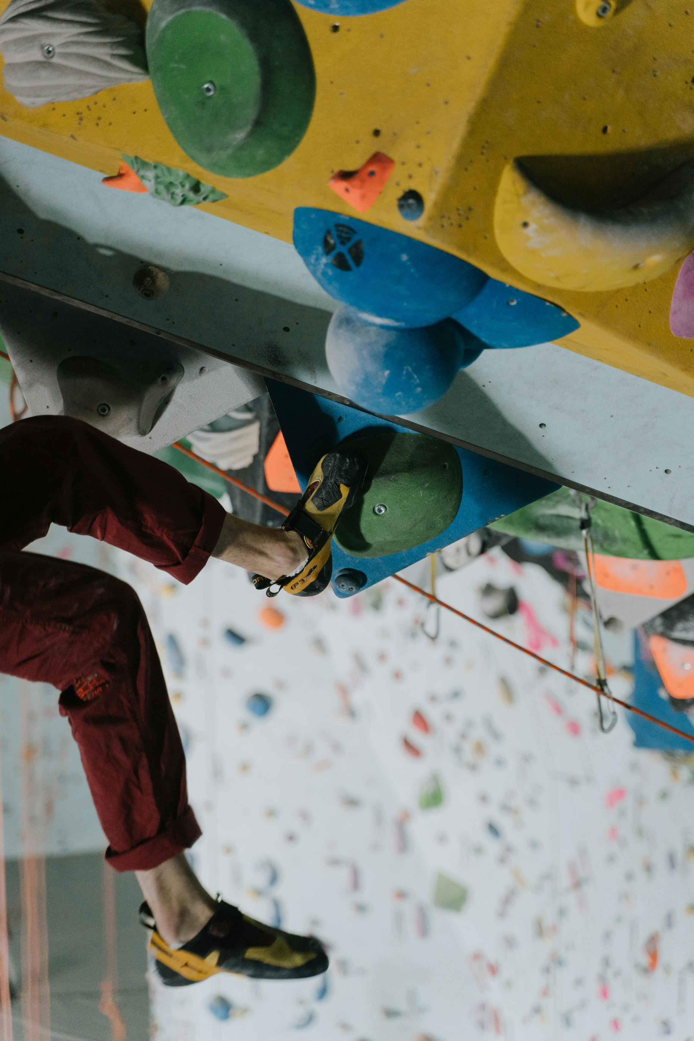 Dynamic indoor rock climbing showcasing agility and strength. Perfect for fitness and sports enthusiasts.
