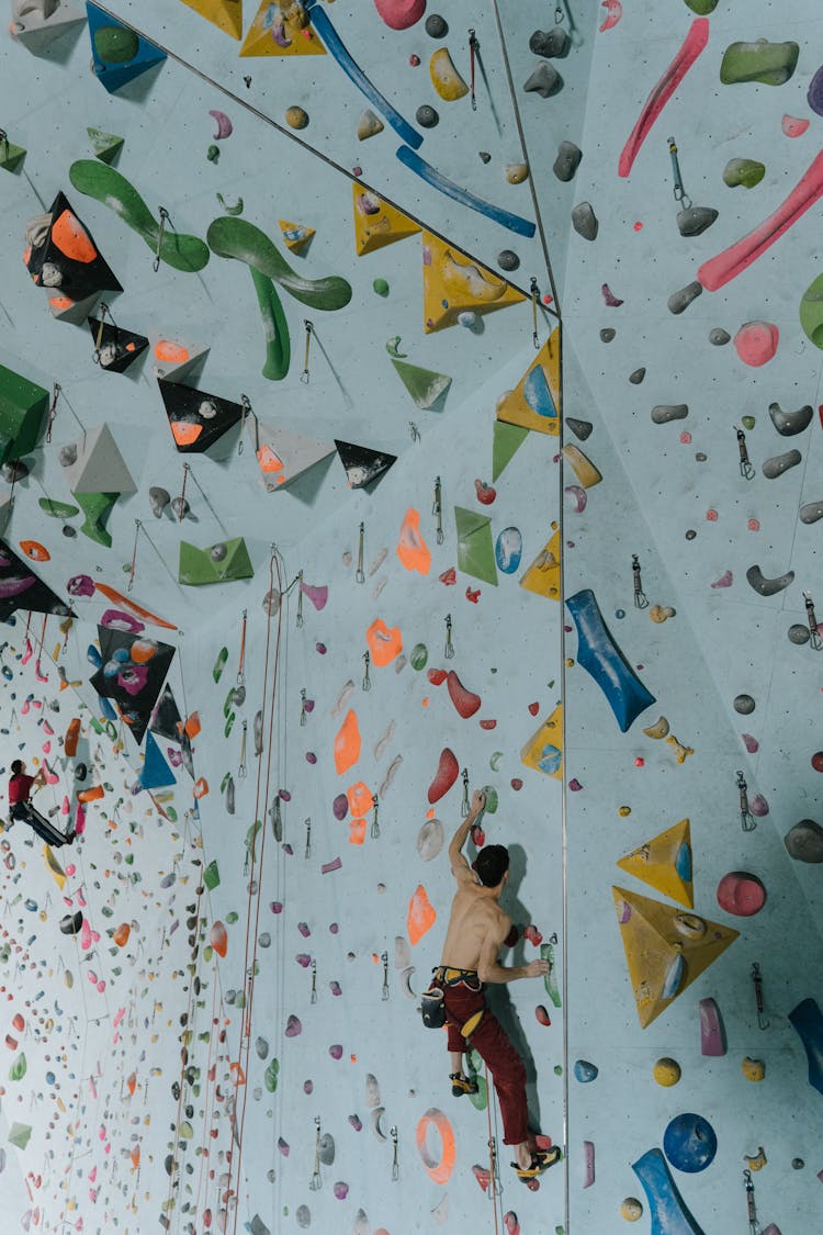 Athletic Shirtless Man Doing Indoor Rock Climbing