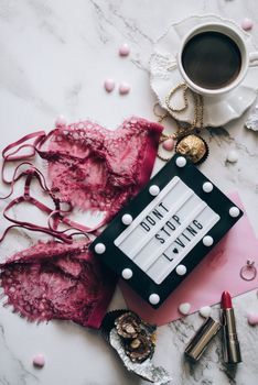 A romantic flat lay with coffee, lingerie, and a lovely message for Valentine's Day.