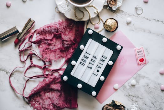 A flat lay featuring lingerie, chocolates, and love-themed props for a romantic ambiance.