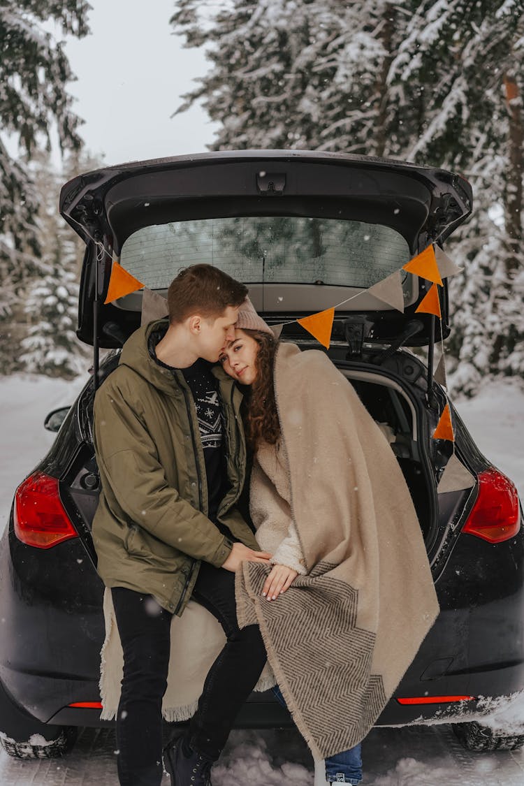 A Couple With A Car In Winter