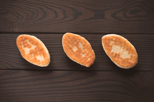 Free A Top View of Breads on a Wooden Table Stock Photo