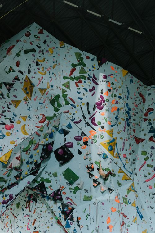 Free A vibrant rock climbing wall featuring various colored holds in an indoor gym setting. Stock Photo