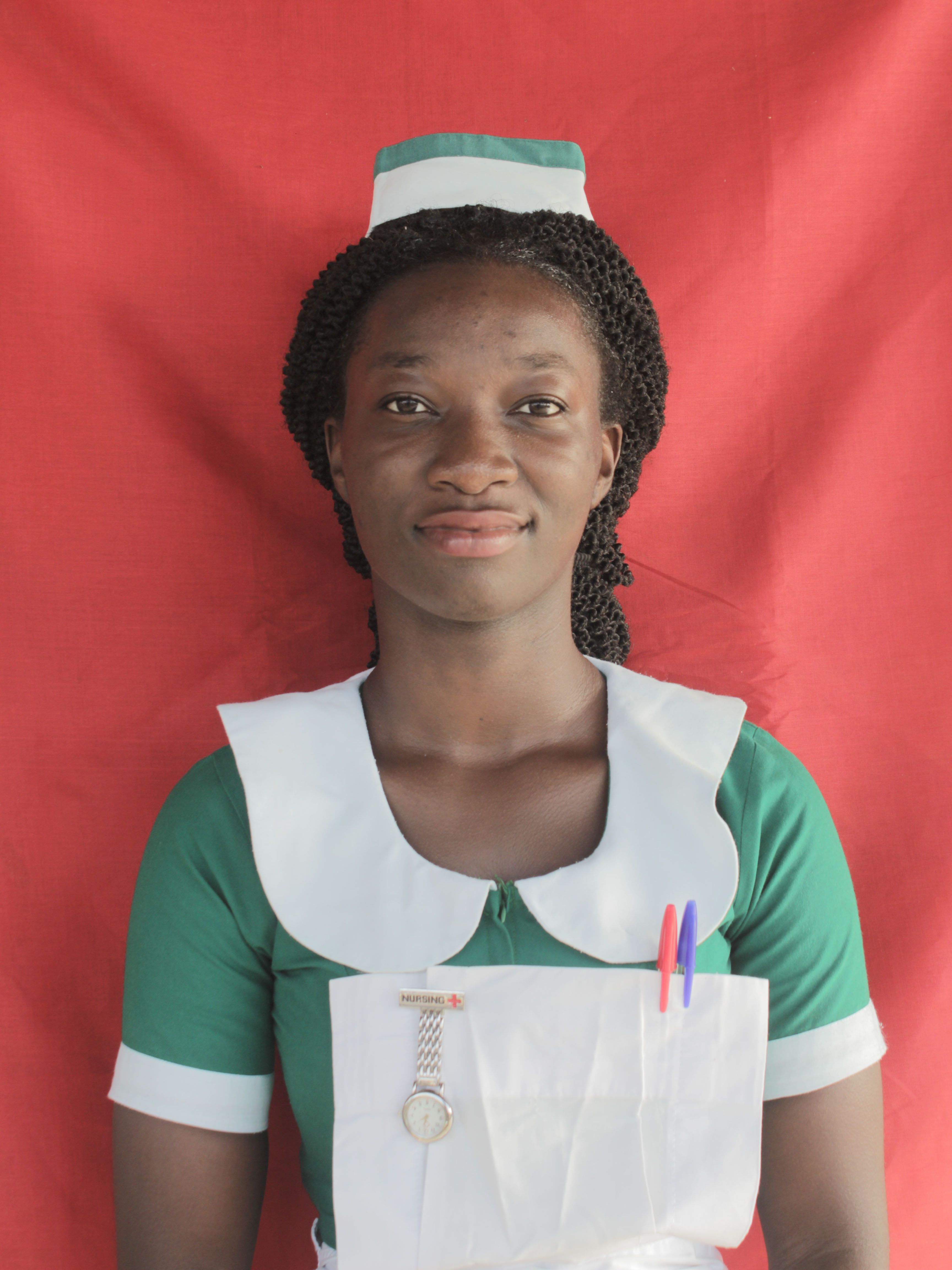 Smiling nurse in uniform against a red background, symbolizing healthcare and professionalism.