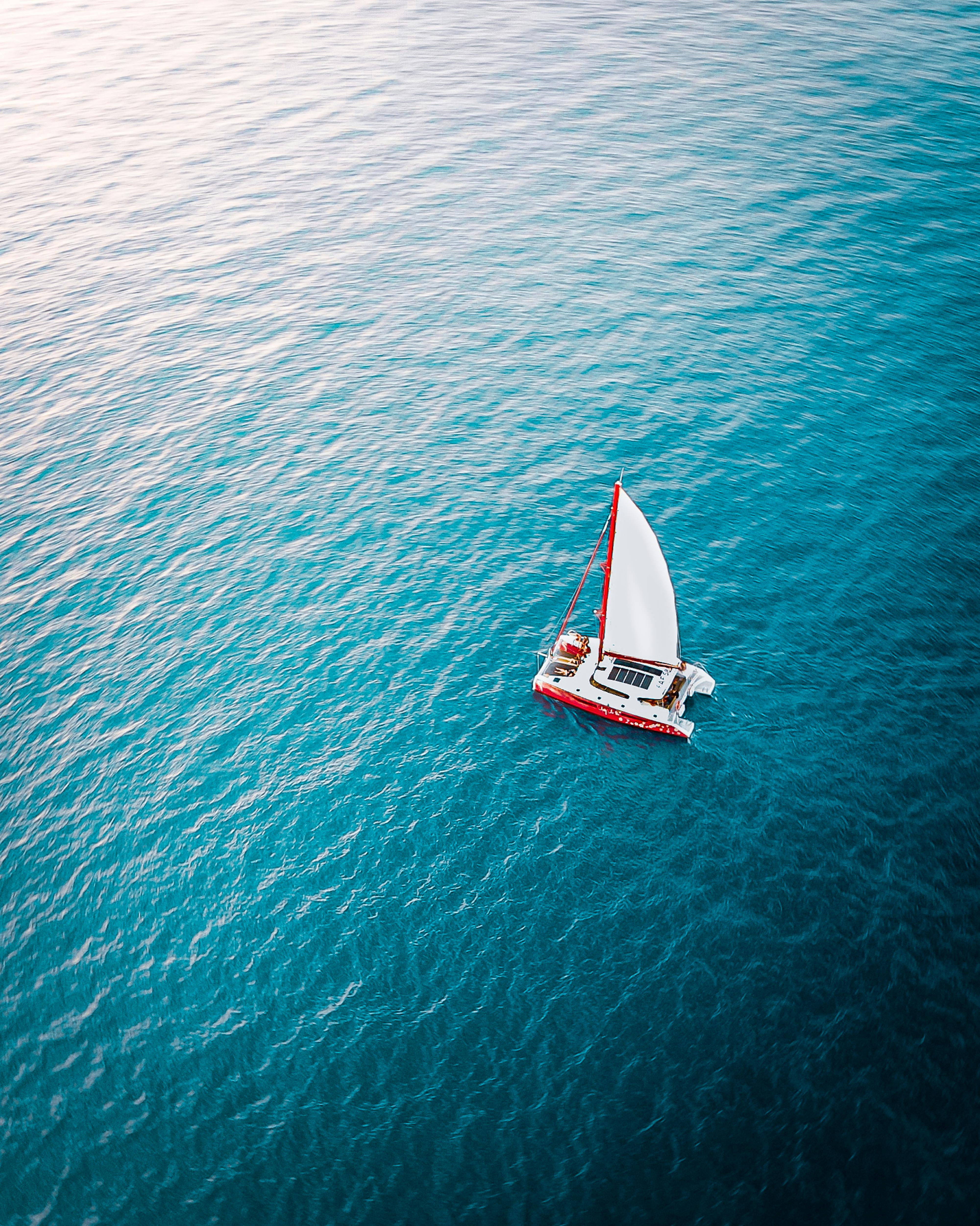 sailboat floating on rippling sea