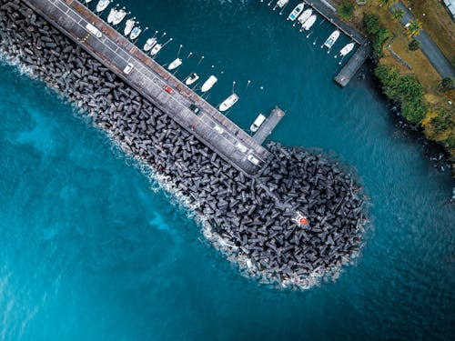 Pier with moored boats and lighthouse