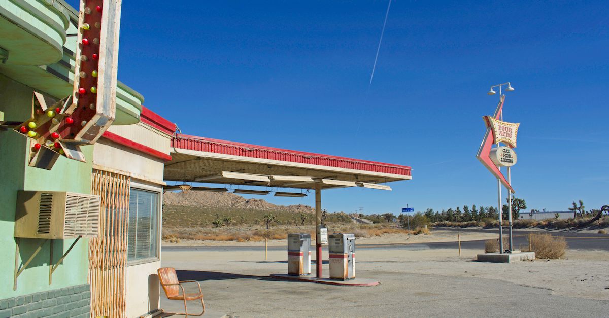 Classic desert gas station in Lancaster, California under a clear blue sky.