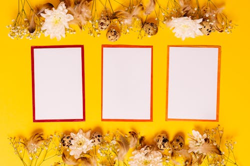Free White and Red Papers on Yellow Background Stock Photo