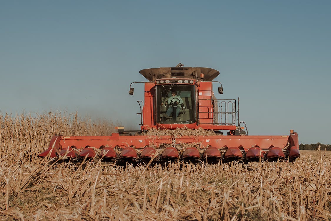 A Low Angle Shot of a Tractor on a Cropland