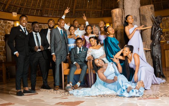 Vibrant group wedding celebration in Dar es Salaam with diverse guests in elegant attire.