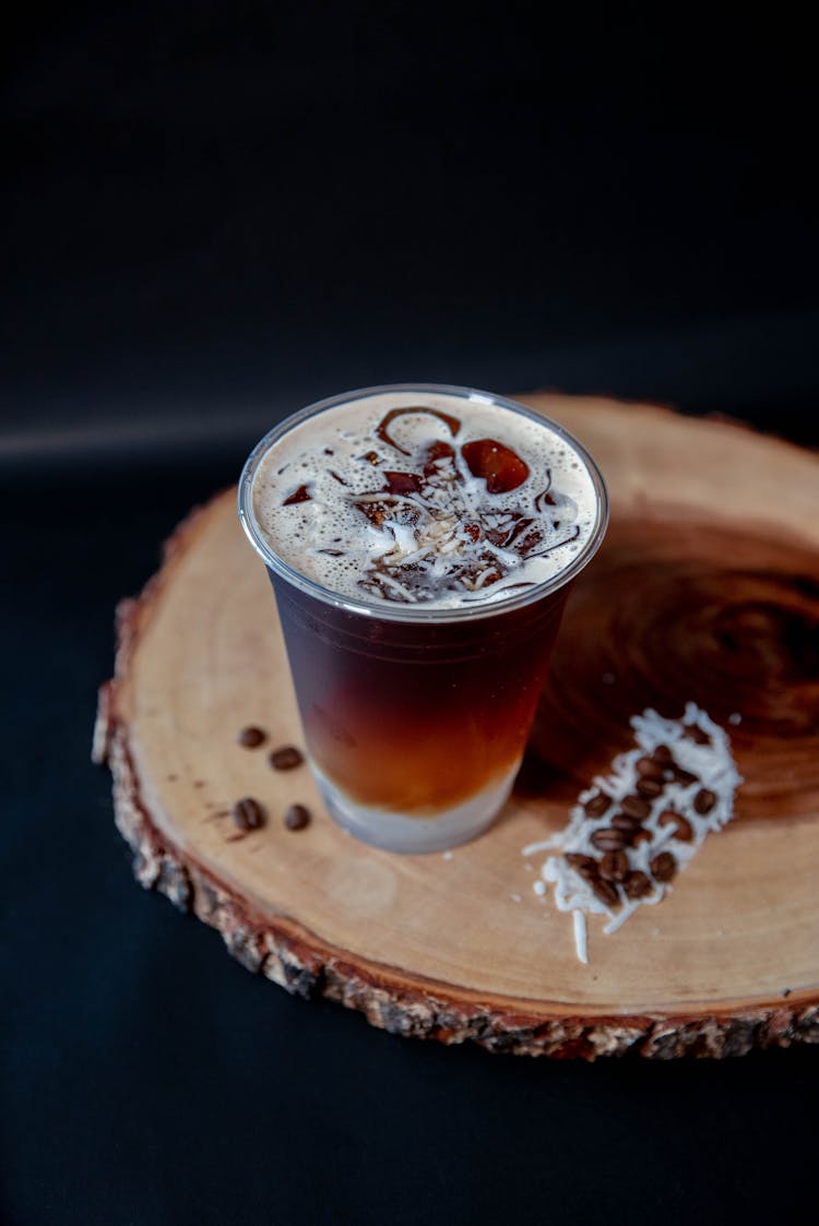 A Glass Of Iced Coffee On A Wooden Coaster