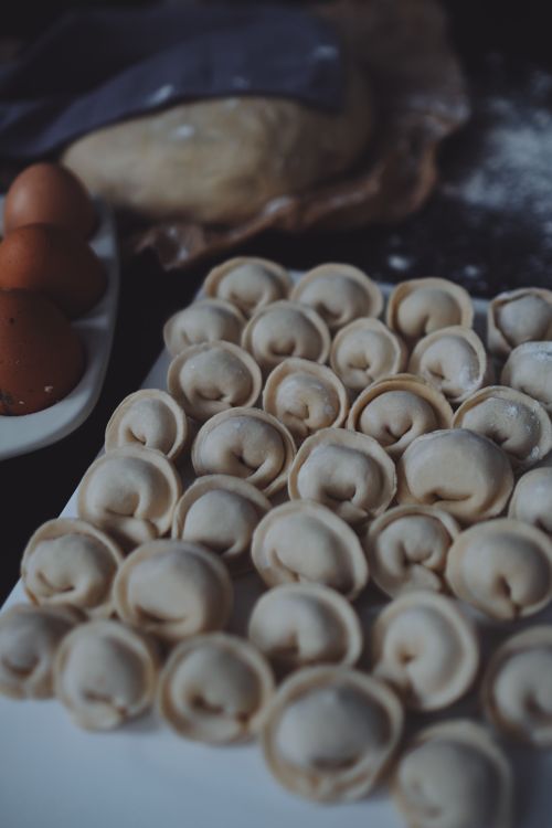 Free A collection of fresh homemade dumplings on a ceramic plate ready for cooking. Stock Photo