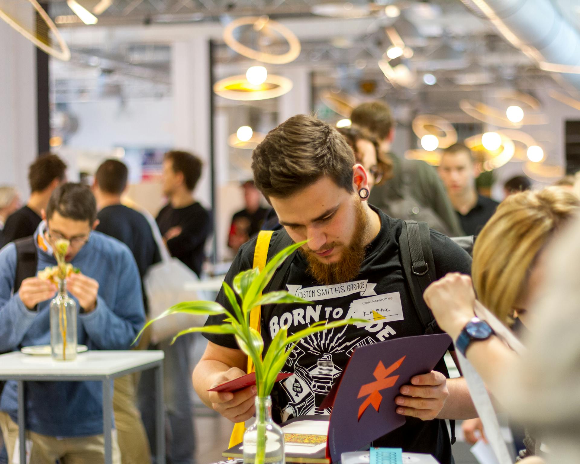 Group of young professionals networking in a modern indoor event.