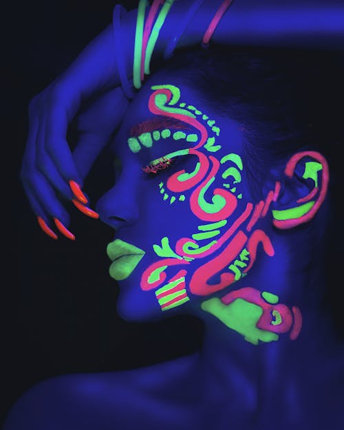 Free A Woman with Neon Paint on Her Face Stock Photo