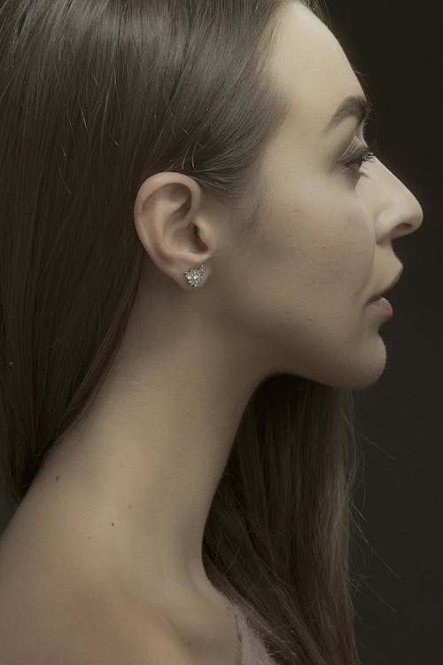 A Side View of a Woman Wearing a Diamond Earring