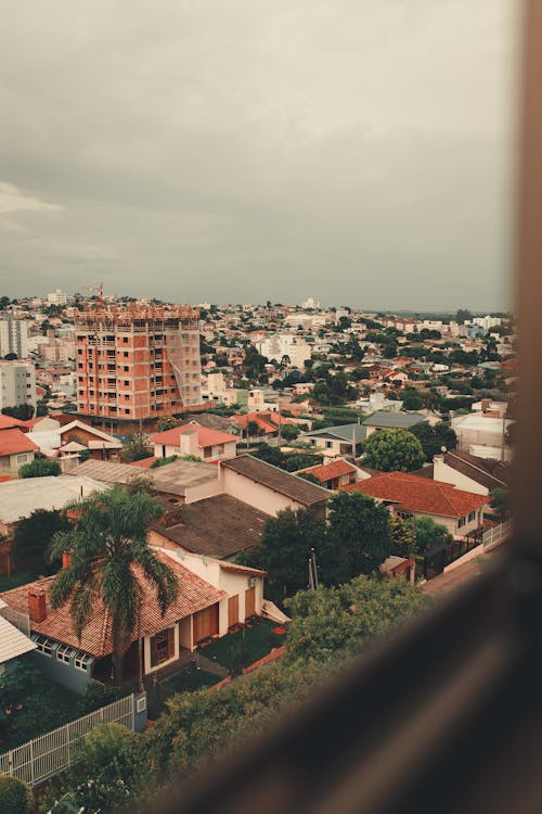 Free Cityscape with different residential houses under cloudy sky Stock Photo