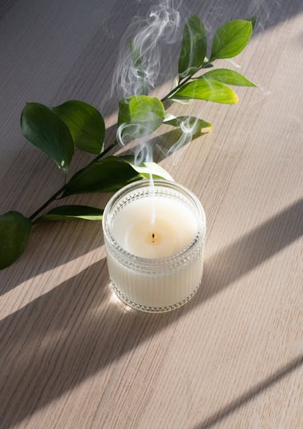 Aromatic candle with steam on table in sunlight · Free Stock Photo