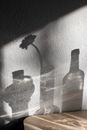 Bottle and jug arranged with vase of flower
