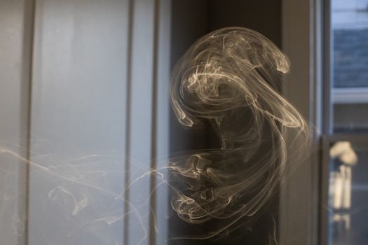 Cigarette smoke in motion in room